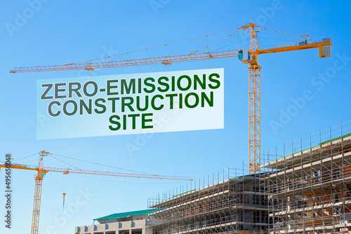 Zero-Emissions and Carbon Neutrality in building activity and construction industry - concept with text and tower crane in a construction site