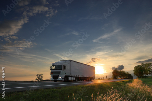 Landscape with a moving truck at sunset 