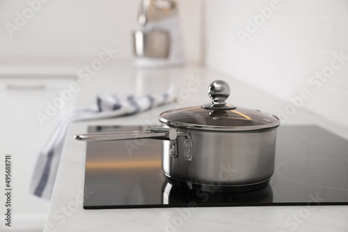 New clean saucepan on cooktop in kitchen