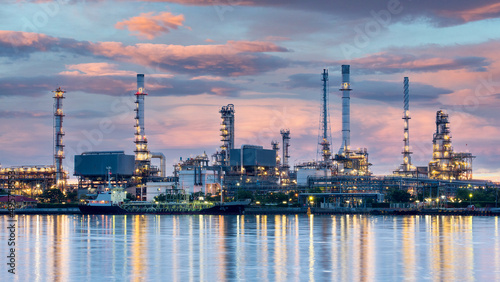 Oil and gas refinery plant area at sunrise near sea port or river