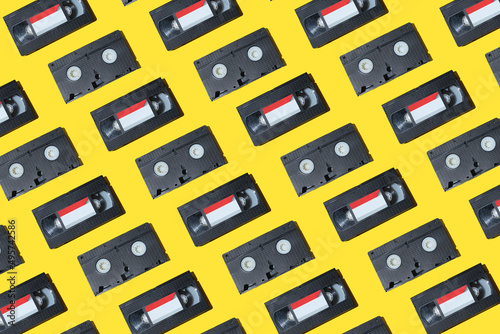 VHS video cassette, Old black videotape pattern on a yellow background, Outdated technology background.