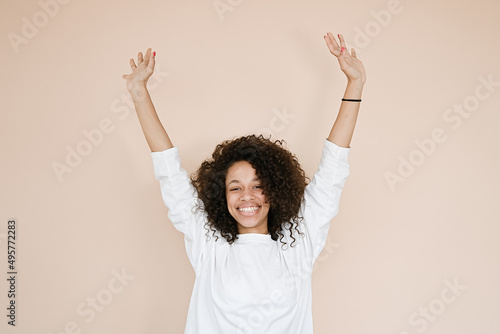 Young african american woman over isolated background celebrating mad and crazy for success with arms raised and closed eyes screaming excited. Winner concept