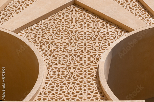 Low angle of a decorated architecture wall exterior with pattern on a sunny day in Doha, Qatar