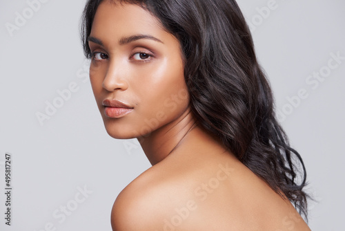 Perfect and natural beauty. Shot of a beautiful young posing over a gray background.