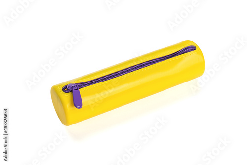 Yellow pencil case with purple lock isolated on a white background. Flat lay.