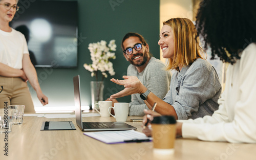 Cheerful businesswoman having a discussion with her colleagues