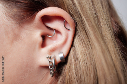 piercings on an ear. Conch and helix piercings close up.