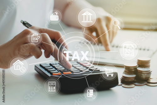 women using calculator calculated individual income tax for pay taxes annual.Financial research,government taxes and calculation tax return concept. Tax and Vat concept.