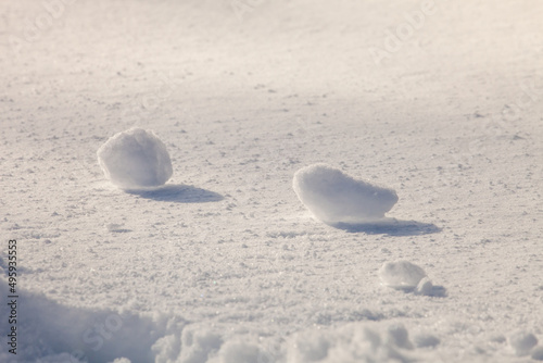pieces of frozen snow on flat snow surface