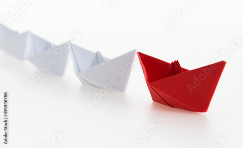 The red origami boat is leader