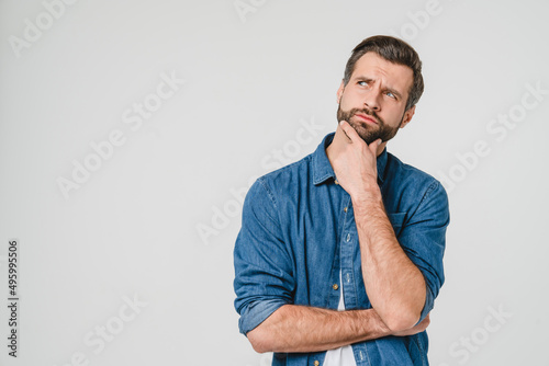 Pensive thoughtful contemplating caucasian young man thinking about future, planning new startup looking upwards isolated in white background