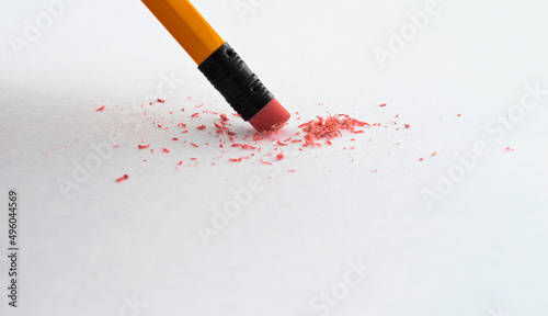 Pencil eraser erasing on white background