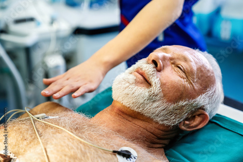 ECG electrodes on mature male patient in hospital before surgery. Healthcare and medicine concept