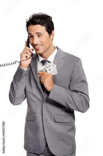 Youd like to invest with me, you say - Unethical. An unethical businessman shoving a wad of cash into his jacket pocket while on a telephone.