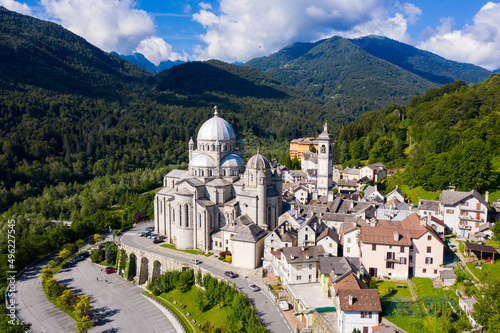 Picturesque summer view from drone of alpine township of Re with pilgrimage church of Virgin Mary surrounded by green Alps, Piedmont, Italy