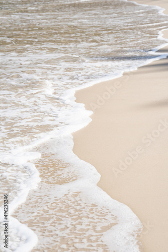 White sand waves texture lapping across untouched Shore.