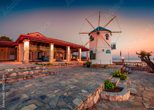 Amazing summer dawn on Potamitis Windmill. Stunning morning scene of Zakynthos island, Korithi location, Ionian Sea, Greece, Europe. Traveling concept background..
