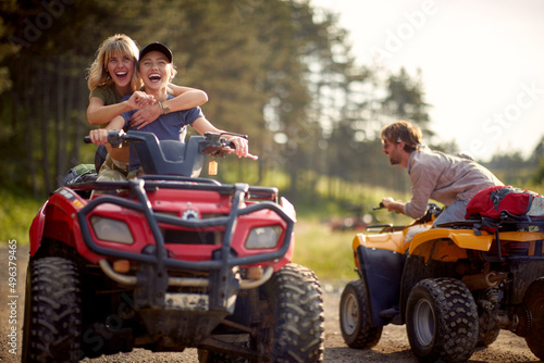 A group of happy friends riding quads on the mountain. Riding, friendship, nature, activity