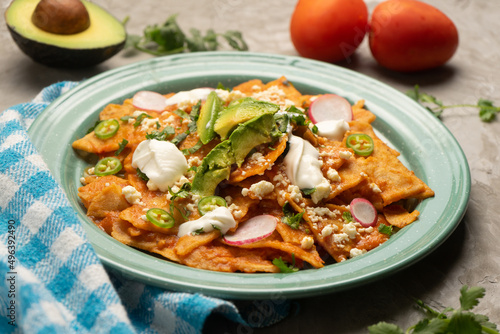 Red chilaquiles with cheese and avocado. Mexican food