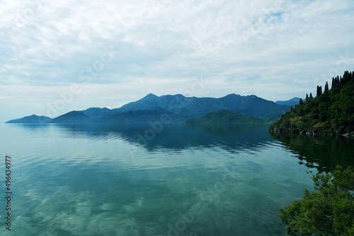 Tranquil panoramic view of the mountains in Skadar lake in Montenegro. Calm turquoise landscape background