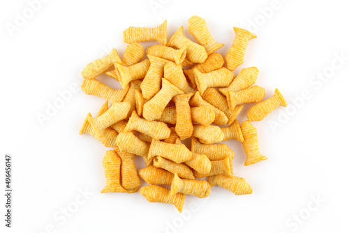 Pile of fish shaped crispy corn puffs isolated on white background