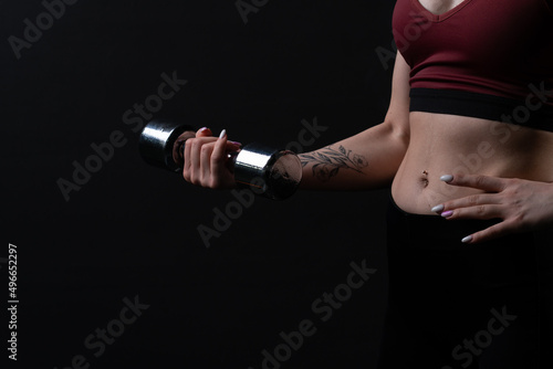 In shiny knightly holds her beautiful as kira a dumbbells hands girl dumbbells fitness body, In the afternoon health woman in exercise and active strength, sportswear biceps. Care ABS