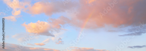 Clear blue sky. glowing pink, golden cirrus and cumulus clouds after storm, soft sunlight. Sunset cloudscape. Meteorology, midnight sun, heaven, peace, graphic resources, picturesque panoramic scenery