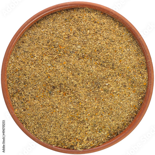Utsho suneli ground in a brown ceramic bowl isolated on white background. Isolated close-up photo of food close up from above on white background.