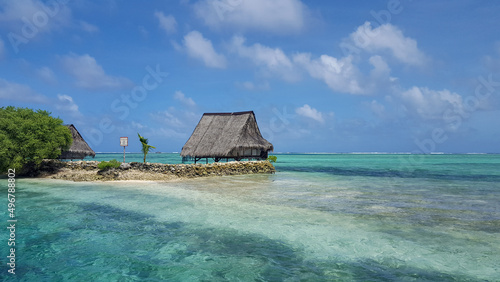 A stunning remote traditional thatched roof house accommodation on white sandy island and turquoise ocean in Pohnpei, Federated States of Micronesia