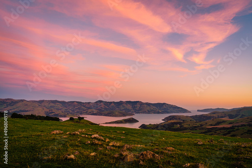Mesmerizing view of the sea with mountains at sunset in Akaroa, Christchurch, New Zealand