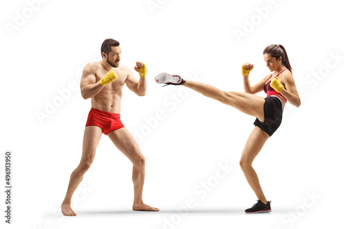 Male and female athlets exercising kick boxing