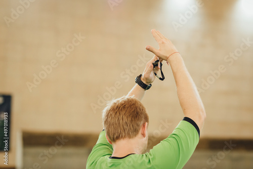 Football referee gesture time out during a football game on on a soccer field