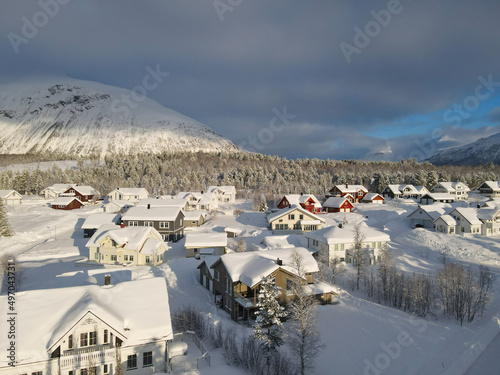 A snow-covered village in a forest in a mountain area