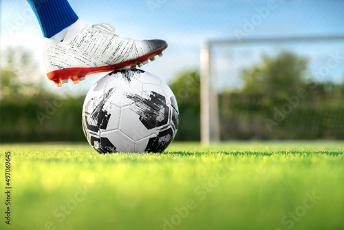 professional football or soccer player kick and shoot ball at penalty or freekick to goalkeeper for winning champion goal in final match league in field stadium