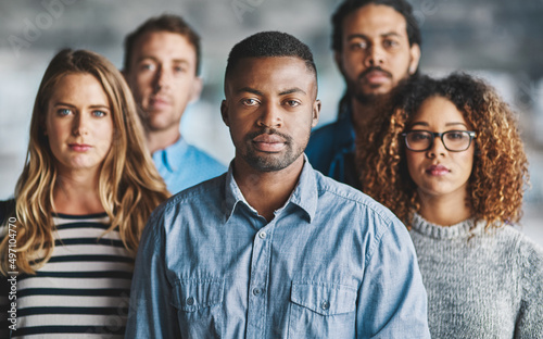 Were the team you want. Portrait of a group of creative businesspeople standing in their office.