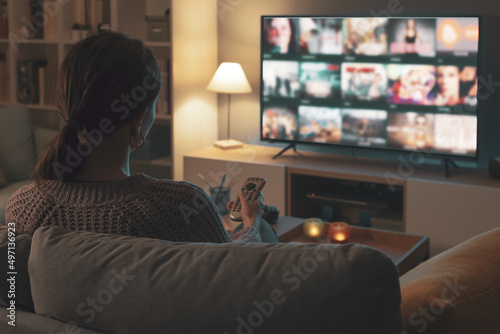 Woman watching TV at home and relaxing
