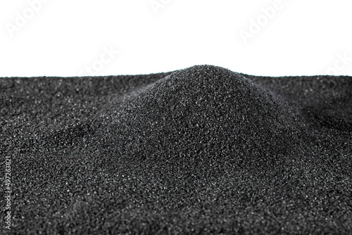Black fine-grained gunpowder for filling rifle cartridge cases, poured in a small pile, highlighted on a white background. Texture of black gunpowder.