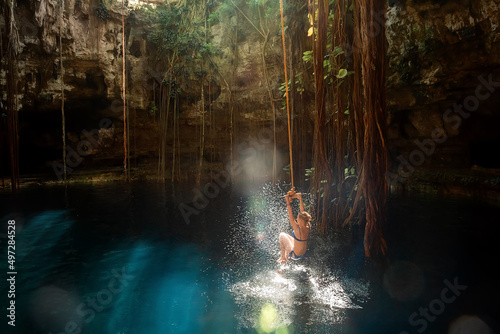  Girl on a bungee. Cenote Ik-Kil Yucatan. Mexico.