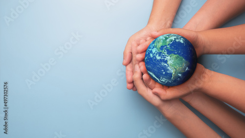 Group of Hands holding earth globe on blue background, International human solidarity day concept, world health day, safe world concept with copy space, Elements of this image furnished by NASA