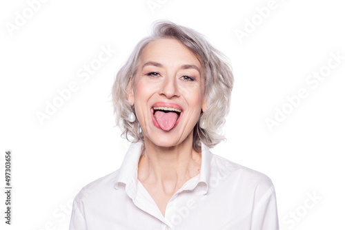 Shot of a beautiful mature woman having fun and teasing sticking out her tongue isolated on white background