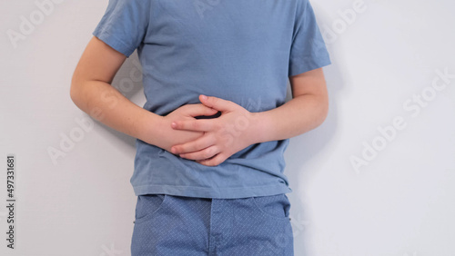 little boy experiences abdominal pain. Baby's medication and health concept. Stomach ache. Suffering a young child. Food poisoning, abdominal pain. Health problems in children.