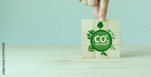 Carbon neutral sustainable development concept. Green industry. Net zero greenhouse gas emissions target 2050. Climate neutral long term strategy. Wooden cube with carbon neutral, save the world icon
