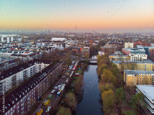 Drone aerial view of Hamburg during sunrise. The skyline of Hamburg over the buildings and canals can be seen on a sunrise time.