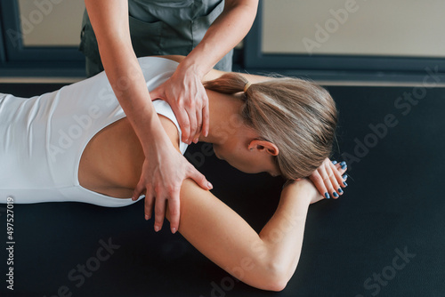 Professional massage. Woman is in health center getting help by doctor