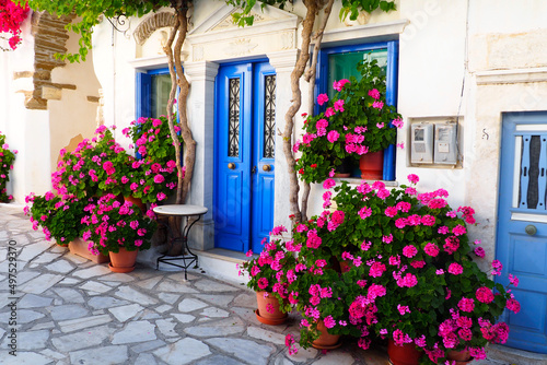 One of the charms of Pyrgos, a famous village of marble craftsmen in Tinos, in the Cyclades, in the heart of the Aegean Sea, are the narrow cobbled streets with white houses and flowers