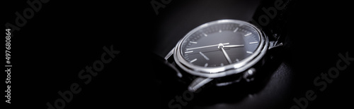 Quartz wristwatch with black dial close-up