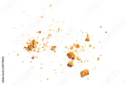 Scattered crumbs of vanilla chip butter cookies isolated on white background. Close-up view of brown crackers. Macro shot of yellow biscuit cake leftovers for your design