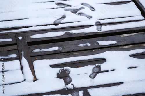 Pontoon covered with melted snow and footprints.