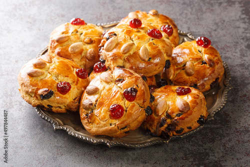 Fat rascal, closely related to the historical turf cake, is a type of cake, similar to a scone or rock cake in both taste and ingredients close-up in a plate on the table. horizontal