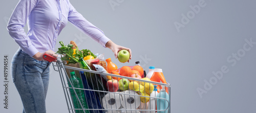 Woman doing grocery shopping at the supermarket